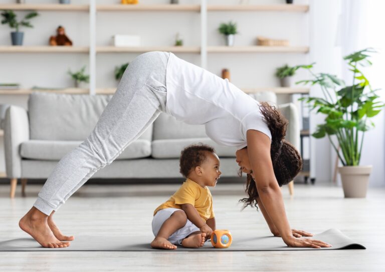 Brown mum and baby doing yoga