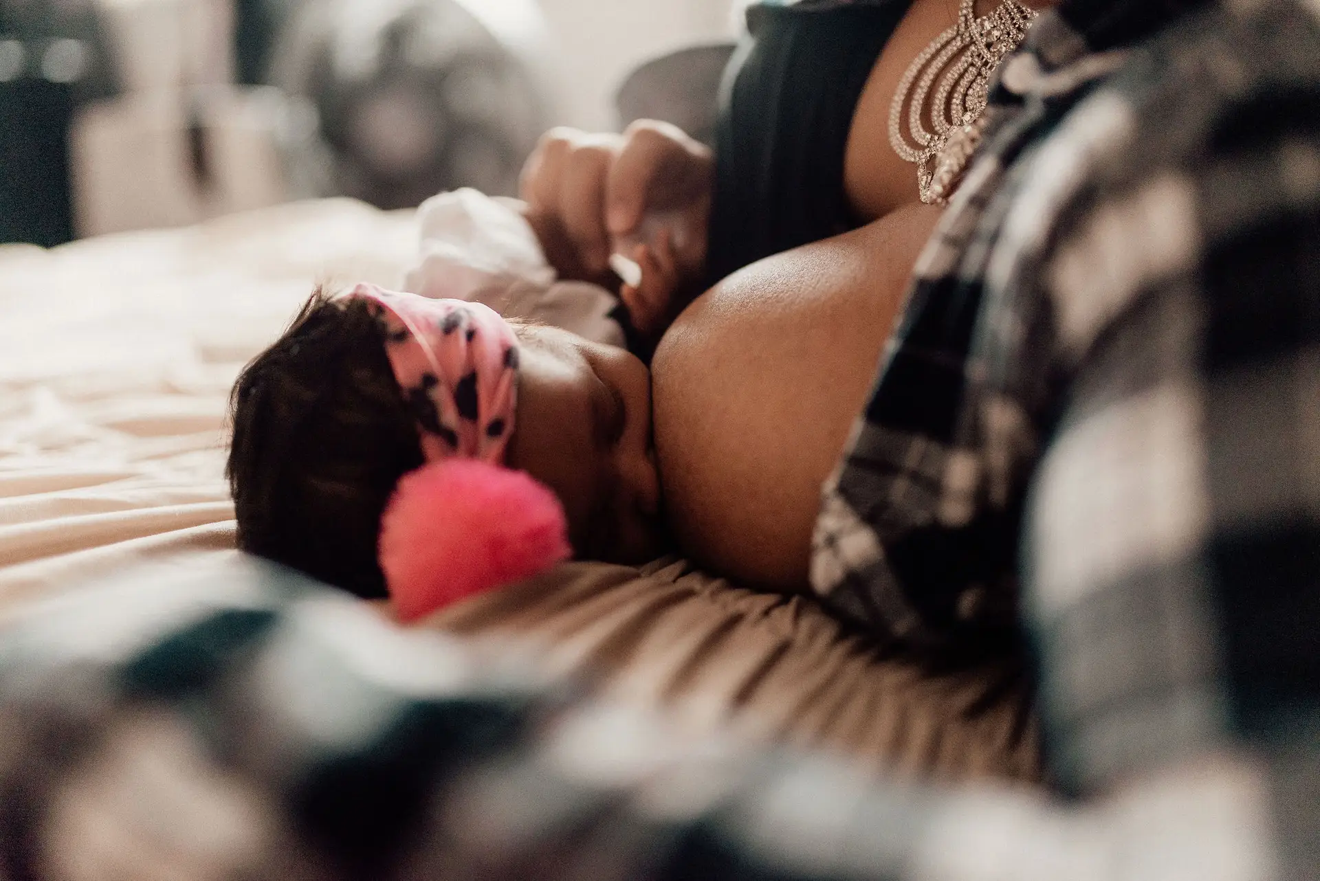 Black family. Baby breastfeeding.