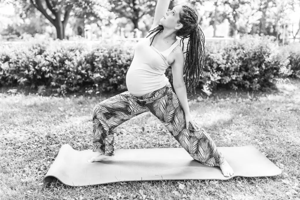 White pregnant person doing yoga